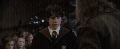 A Young Man In A Harry Potter Costume Talks To A Man In A Leather Jacket GIF
