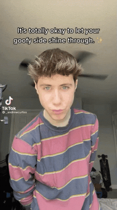 A Young Man In A Pink And Blue Striped Shirt Is Making A Funny Face In A Tik Tok GIF