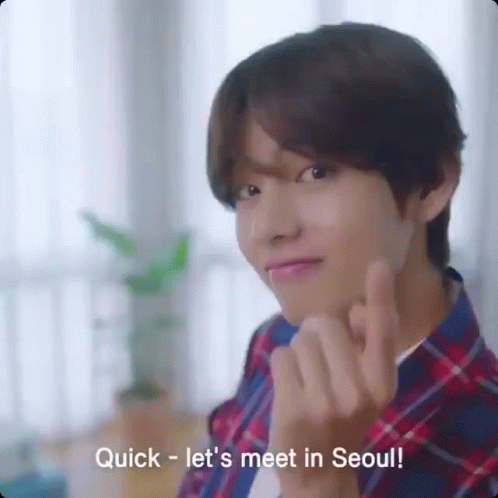 A Young Man In A Plaid Shirt Is Making A Heart Shape With His Fingers And The Words Quick Let 'S Meet In Seoul GIF
