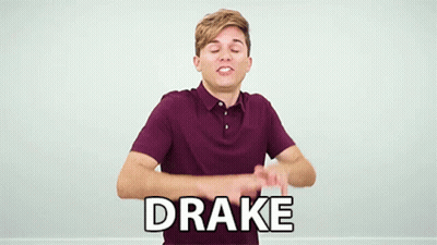 A Young Man In A Purple Shirt Is Making A Funny Face And Says Drake In White Letters . GIF