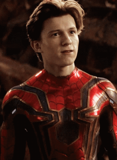 A Young Man In A Red And Gold Spiderman Costume GIF