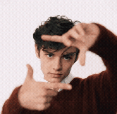 A Young Man In A Red Sweater Making A Frame With His Hands GIF