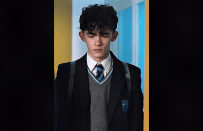 A Young Man In A School Uniform With The Letter T On His Jacket . GIF