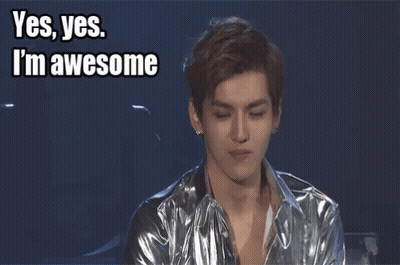 A Young Man In A Silver Jacket Waves His Hand With The Words Yes Yes I 'M Awesome Above Him GIF