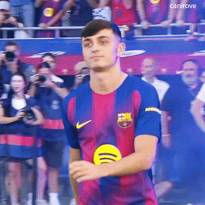 A Young Man In A Soccer Jersey Is Standing In Front Of A Crowd . GIF