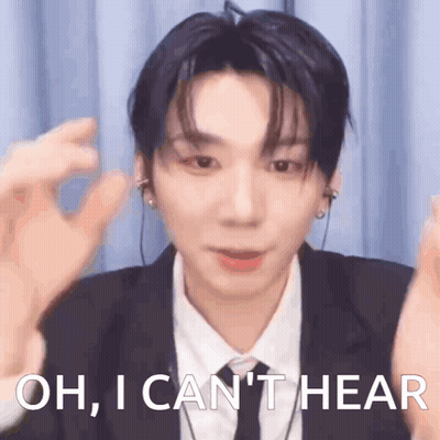 A Young Man In A Suit And Tie Is Saying Oh , I Can 'T Hear GIF
