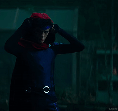 A Young Man In A Superhero Costume With A Scarf Around His Neck GIF