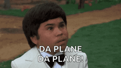 A Young Man In A Tuxedo And Bow Tie Is Saying Da Plane Da Plane ! GIF