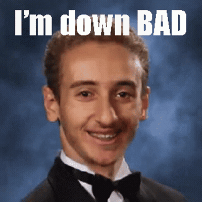 A Young Man In A Tuxedo With The Words I 'M Down Bad Written Above Him GIF