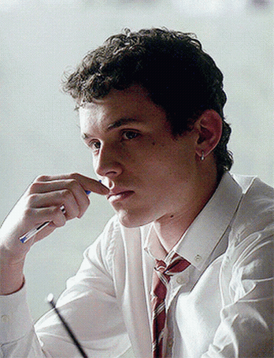 A Young Man In A White Shirt And Red Tie Is Holding A Pen To His Nose GIF