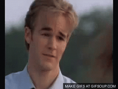 A Young Man In A White Shirt And Tie Is Looking At The Camera With A Sad Look On His Face . GIF