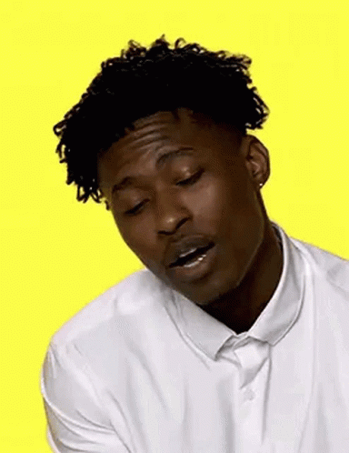 A Young Man In A White Shirt And Tie Is Smiling . GIF