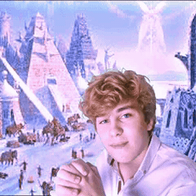 A Young Man In A White Shirt Stands In Front Of A Painting Of Pyramids GIF