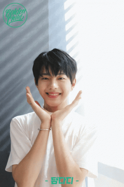 A Young Man In A White Shirt With The Name Golden Child On The Bottom Right GIF