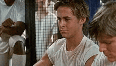 A Young Man In A White T-Shirt Is Sitting Next To Another Young Man In A Locker Room . GIF