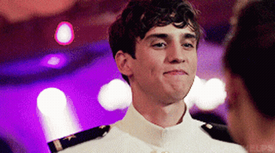 A Young Man In A White Uniform Looks At A Woman GIF