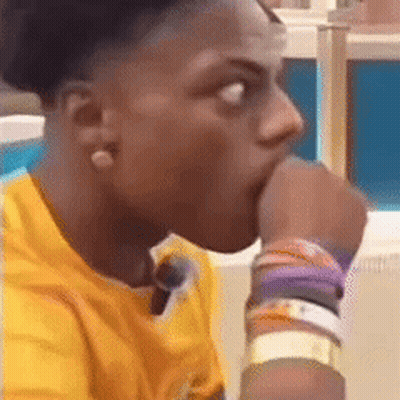 A Young Man In A Yellow Shirt Is Biting His Thumb . GIF