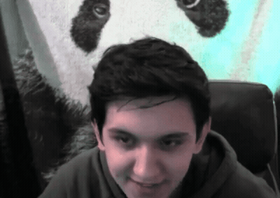 A Young Man In Front Of A Panda Bear GIF