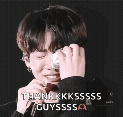 A Young Man Is Crying And Holding A Tissue In His Hand . GIF