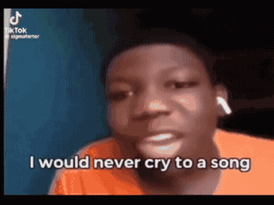 A Young Man Is Crying While Wearing Ear Buds And Says `` I Would Never Cry To A Song '' . GIF