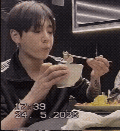 A Young Man Is Eating A Bowl Of Food With Chopsticks And The Date 17:29 GIF
