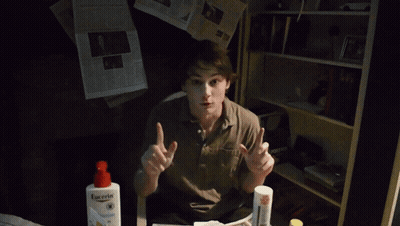 A Young Man Is Holding A Newspaper That Says The New York Journal On It GIF