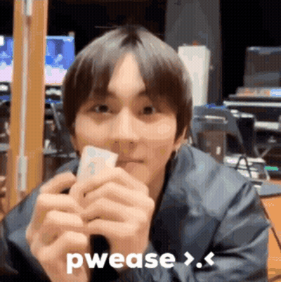 A Young Man Is Holding A Piece Of Paper In His Hands And Says Pwease > . GIF