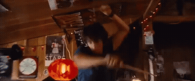 A Young Man Is Holding A Piece Of Wood In His Hands And Making A Funny Face . GIF
