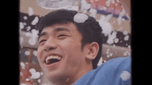 A Young Man Is Laughing While Bubbles Are Coming Out Of His Head . GIF