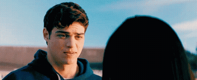 A Young Man Is Looking At A Young Woman . GIF