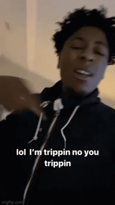 A Young Man Is Making A Funny Face While Wearing A Black Hoodie . GIF