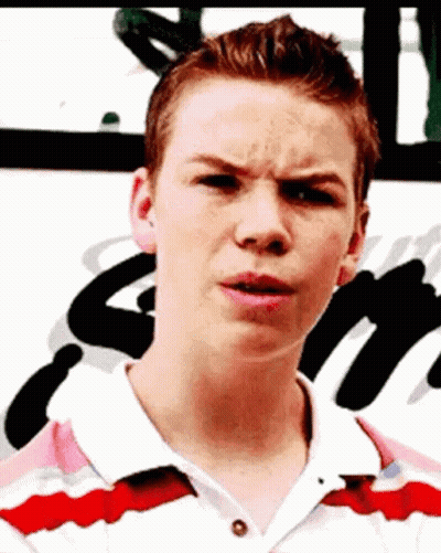 A Young Man Is Making A Funny Face While Wearing A Red And White Shirt . GIF