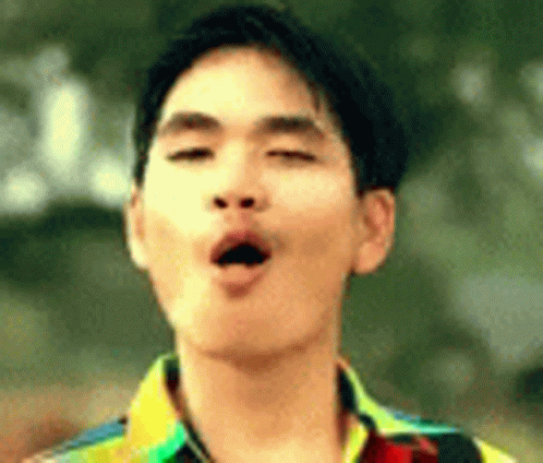 A Young Man Is Making A Funny Face With His Eyes Closed And His Mouth Open . GIF