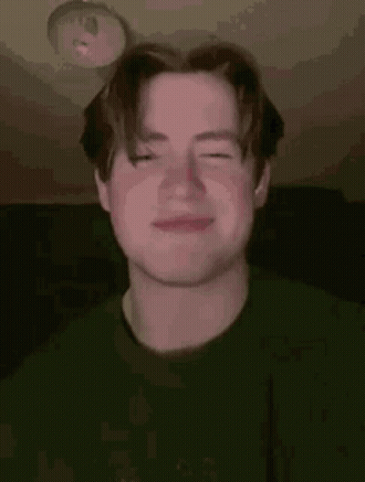 A Young Man Is Making A Funny Face With His Eyes Closed . GIF