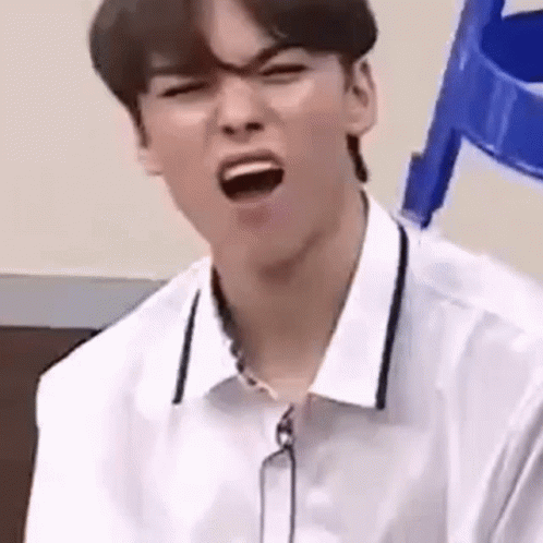 A Young Man Is Making A Funny Face With His Mouth Open . GIF
