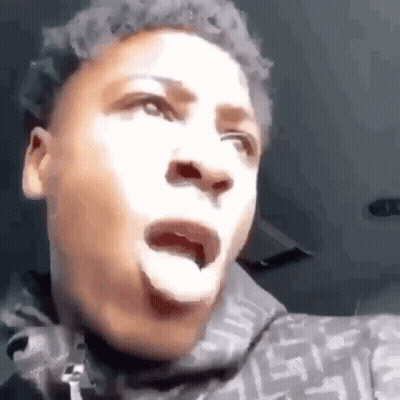 A Young Man Is Making A Funny Face With His Tongue Out . GIF