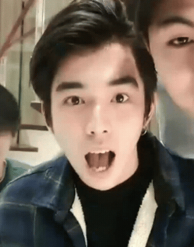 A Young Man Is Making A Funny Face With His Tongue Sticking Out . GIF