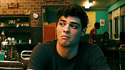 A Young Man Is Sitting At A Table In A Diner . GIF