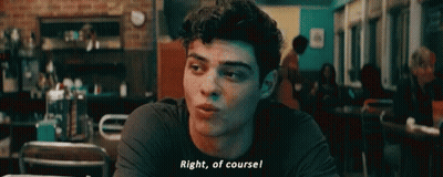 A Young Man Is Sitting At A Table In A Restaurant And Talking To Someone . GIF