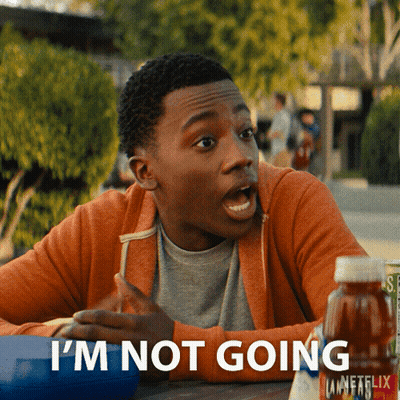 A Young Man Is Sitting At A Table With A Bottle Of Unfflix In Front Of Him GIF