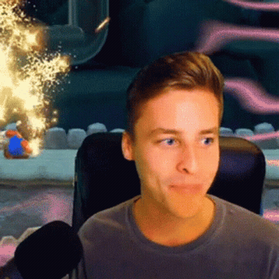 A Young Man Is Sitting In A Chair With A Microphone In Front Of Him Looking At The Camera . GIF