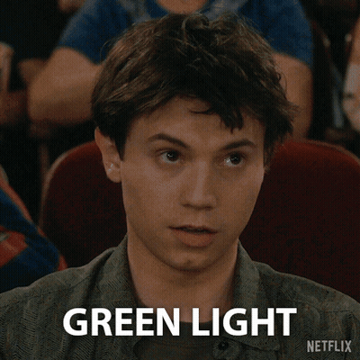 A Young Man Is Sitting In A Theater And Says Green Light Netflix GIF