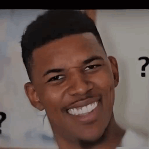 A Young Man Is Smiling And Making A Funny Face . GIF