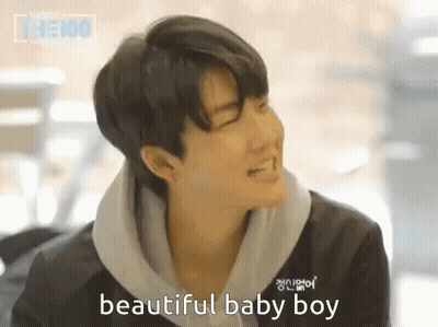 A Young Man Is Smiling And Says Beautiful Baby Boy In A Foreign Language GIF