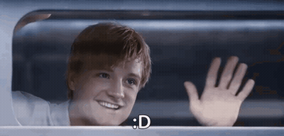 A Young Man Is Smiling And Waving His Hand While Looking Out Of A Window . GIF