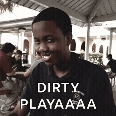 A Young Man Is Smiling With The Words Dirty Playaaa On His Shirt GIF