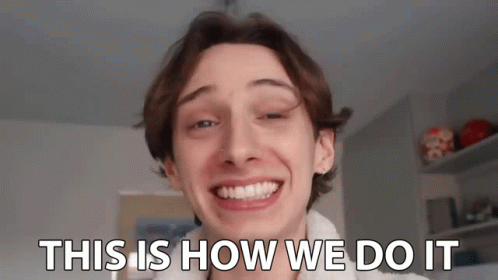 A Young Man Is Smiling With The Words `` This Is How We Do It '' Written On His Face . GIF