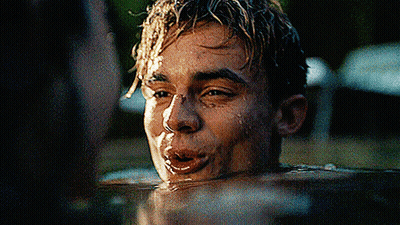 A Young Man Is Swimming In A Pool And Making A Face . GIF