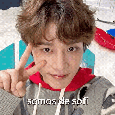 A Young Man Is Taking A Selfie In The Snow And Making A Peace Sign With His Finger . GIF