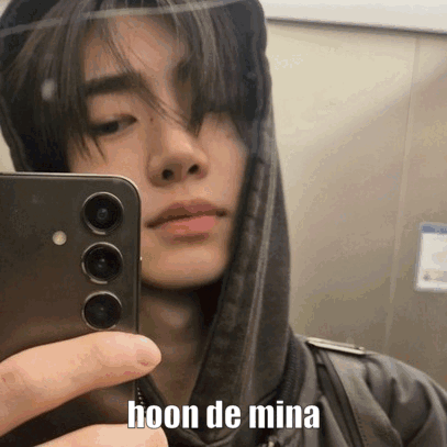 A Young Man Is Taking A Selfie With His Cell Phone . GIF